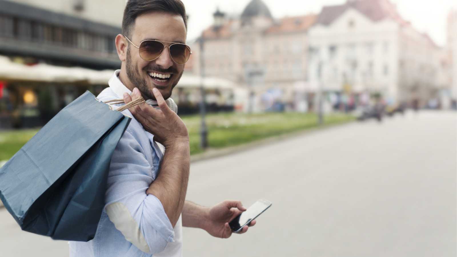 Happy man walking with mobile