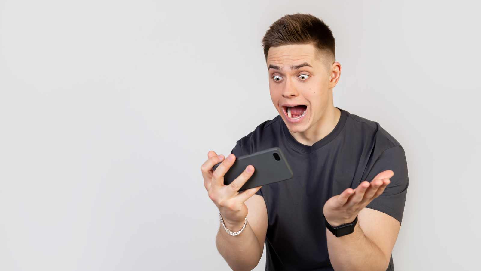 Man shocked seeing phone.