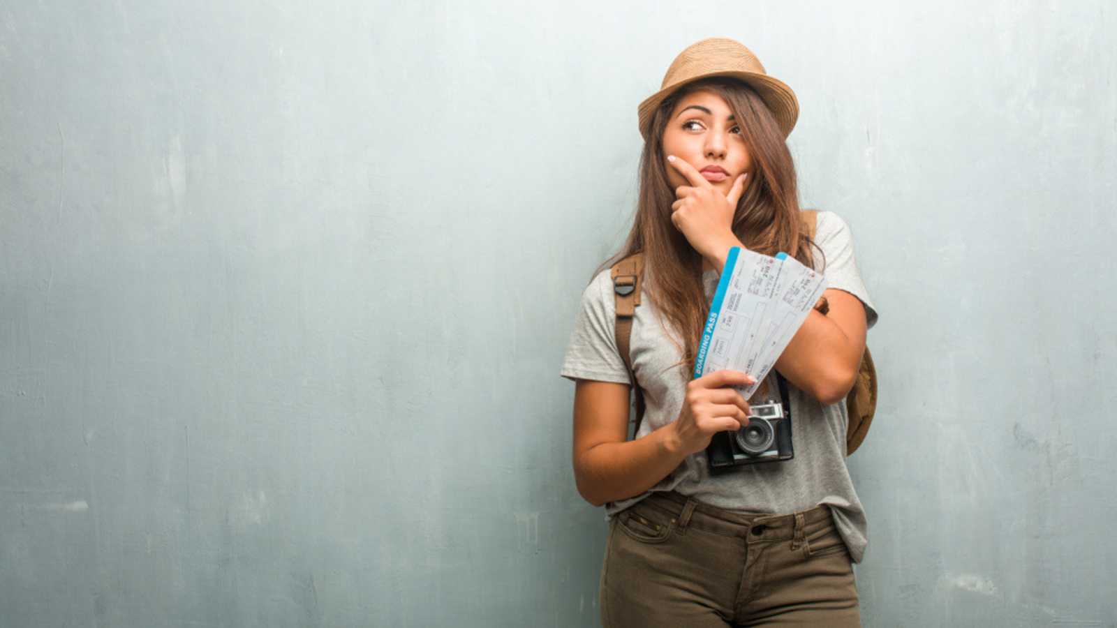 Woman having flight ticket in hand.