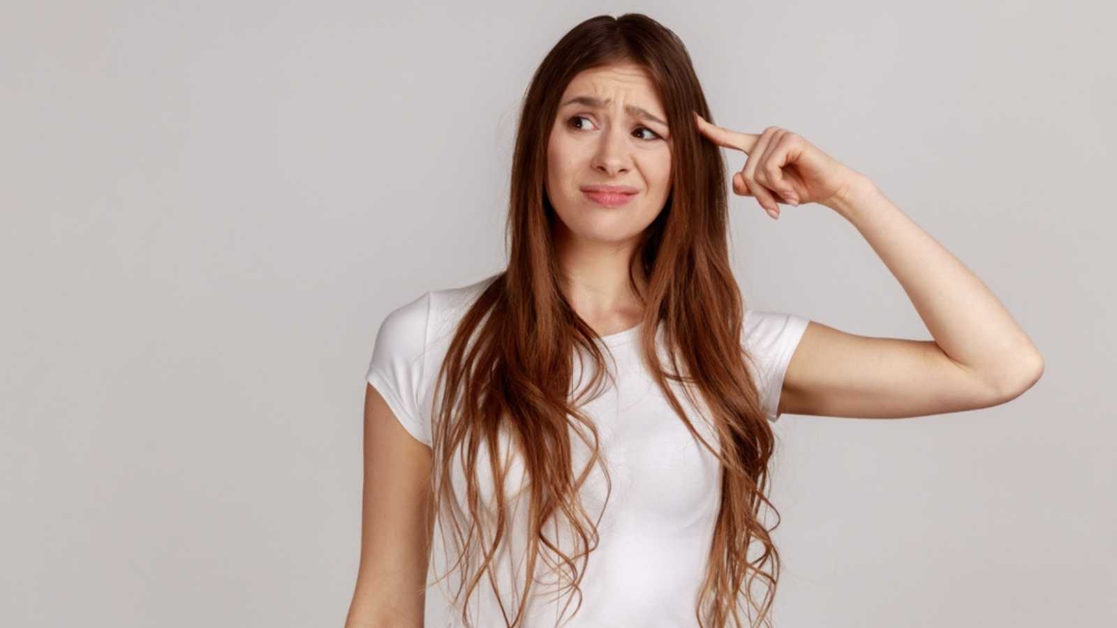 Woman thinking with hands on head