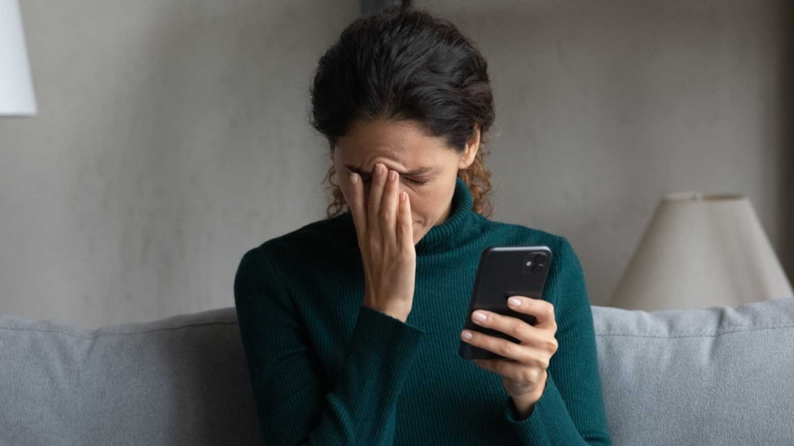 Woman with mobile disappointed