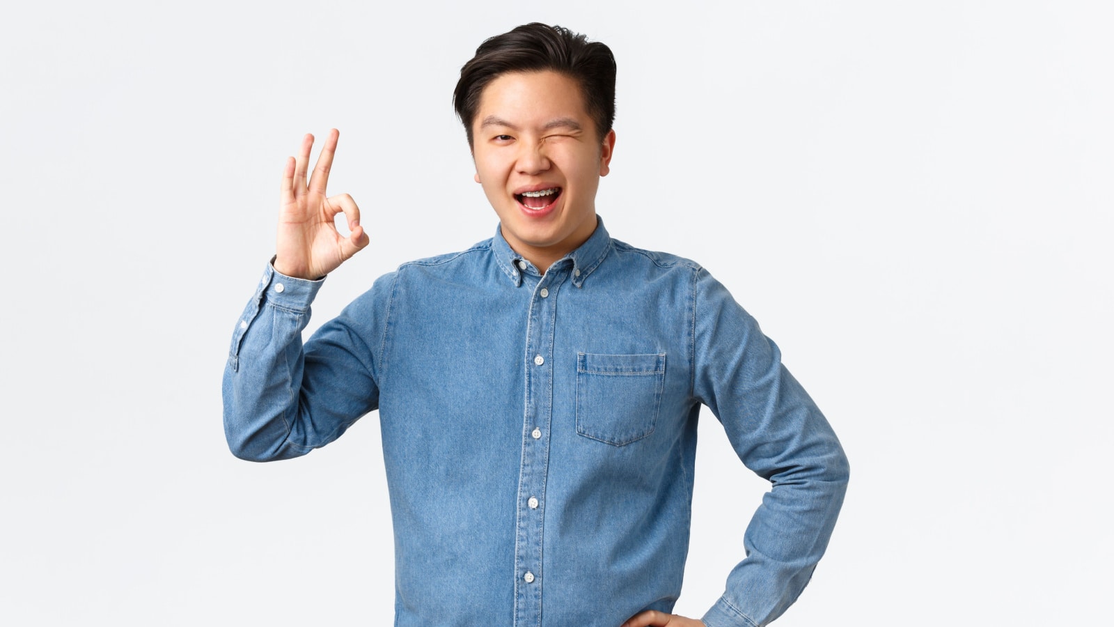 confident Asian man winking OK 