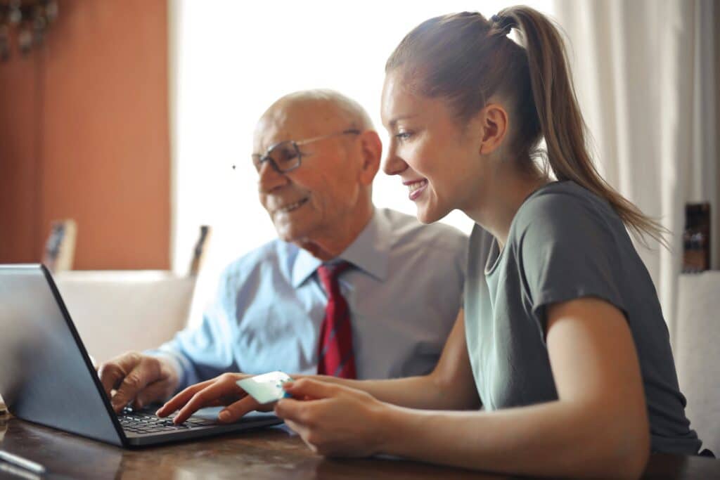 a man and a women working on a laptop