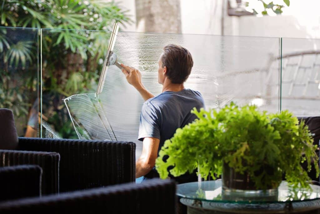 Man cleaning a mirror