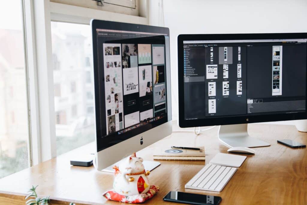 2 laptop screens, set in a workspace